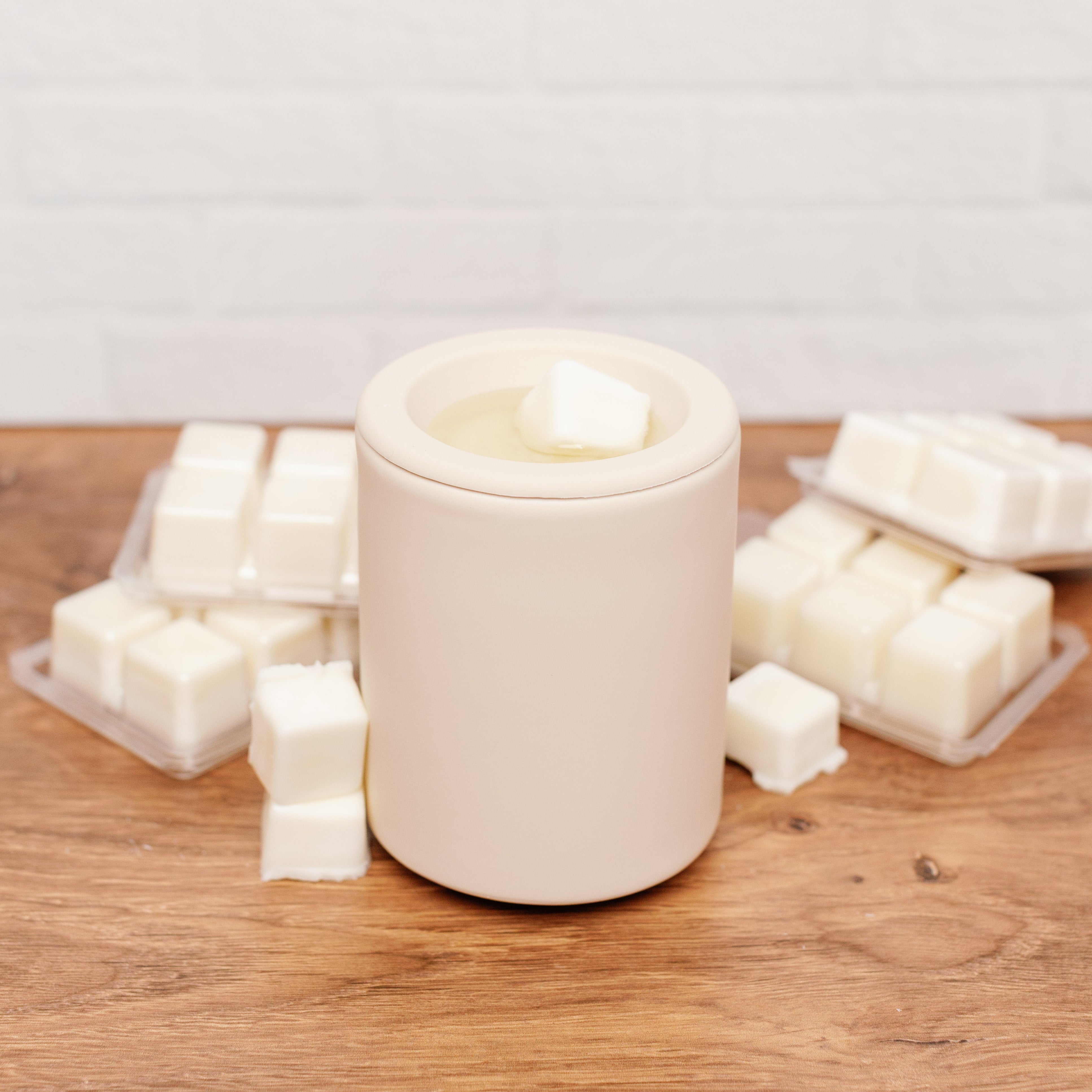 wax melter showing one cube melting and various wax melt clamshells surrounding it